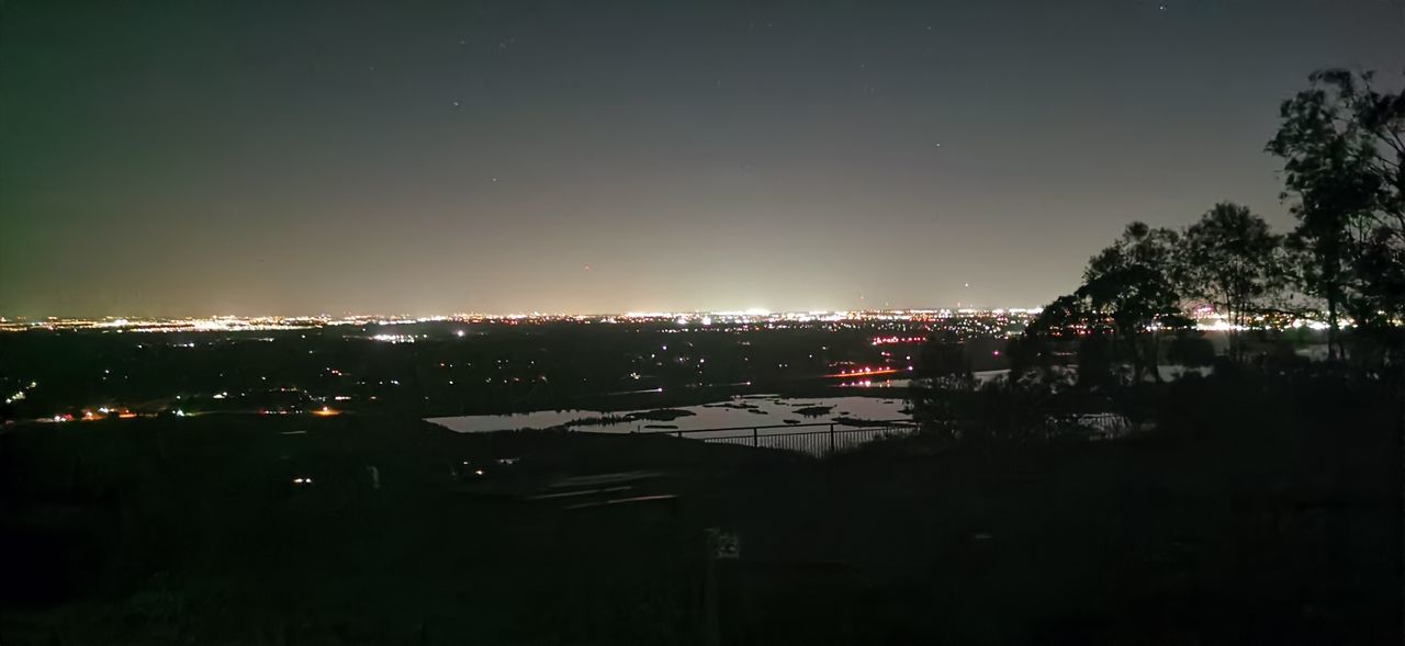 ILLUMINATED BUILDINGS IN CITY AT NIGHT