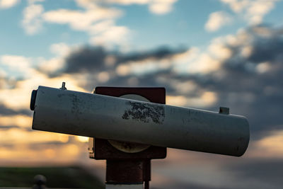 Close-up of information sign against sky