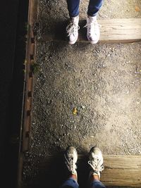 Low section of people standing on railroad ties