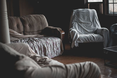 Eye level view of some furniture in an old abandoned house in new orleans.