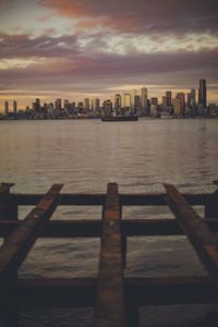 View of city at waterfront during sunset