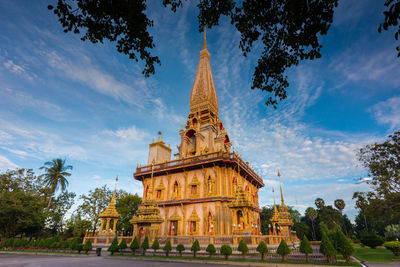 Statue of temple against cloudy sky