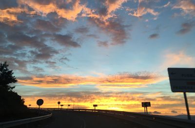 Road against cloudy sky at sunset