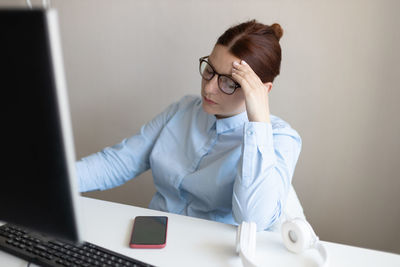 Young woman using laptop at office