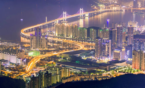 High angle view of illuminated city buildings at night