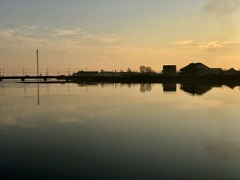 Scenic view of lake against sky during sunset