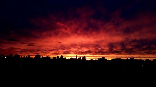 Silhouette of landscape against cloudy sky