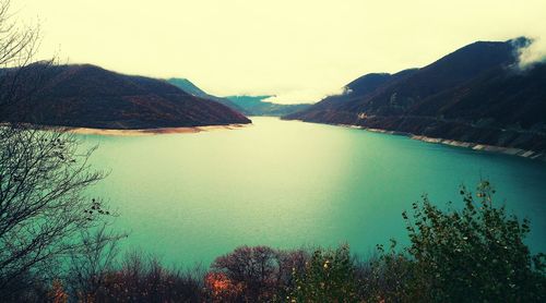 Scenic view of lake and mountains against clear sky