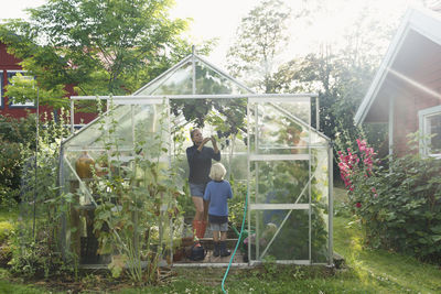 Mother with son in greenhouse