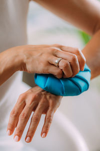 Wrist pain treatment. woman holding ice bag compress on a painful wrist.