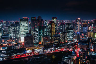 Aerial view of city lit up at night