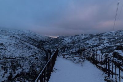 Scenic view of snow covered mountains against sky