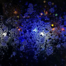 Close-up of illuminated lights in water at night