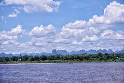 Scenic view of sea and mountains against sky