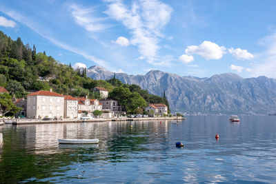 Scenic view of lake and buildings against sky