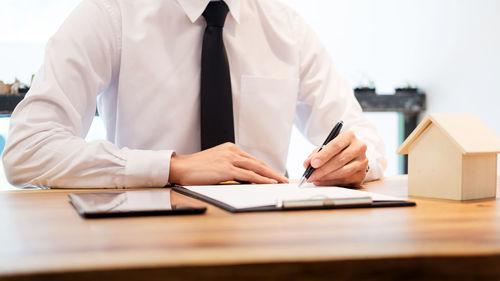 Rear view of man working on table