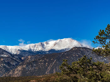 Scenic view of snowcapped mountains against clear blue sky