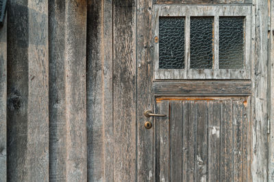 Close-up of closed window of old building