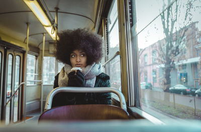 Portrait of man sitting in train