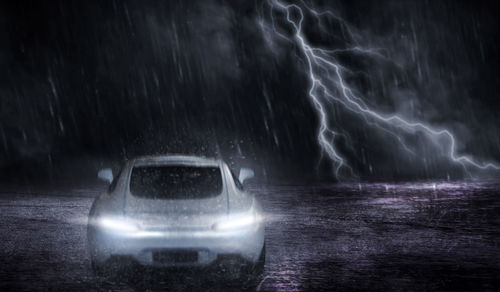 Light painting of wet car at night