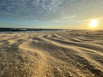 Scenic view of beach against sky during sunset