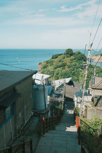 High angle view of buildings by sea against sky