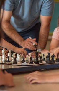 Cropped image of people playing chess