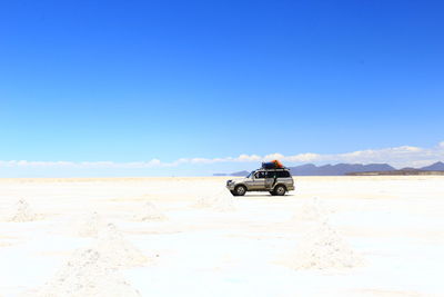 Boat on desert against sky