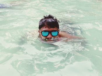 Portrait of boy swimming in pool
