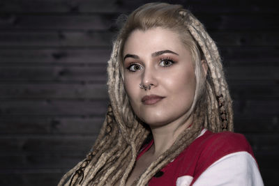 Pretty blonde woman with confident dreadlocks looking at camera