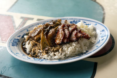 Char siu with rice in plate on table