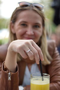 Portrait of a smiling young woman with drink