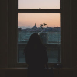 Woman looking through window