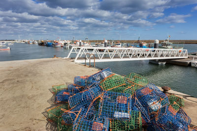 Fishing net on beach against sky