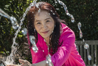 Portrait of a smiling young woman in water