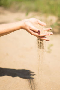 Human hand on sand