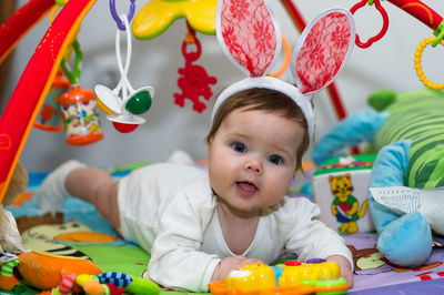 Portrait of cute girl playing with toys