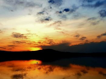 Scenic view of lake against romantic sky at sunset