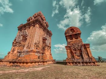 Low angle view of temple against cloudy sky