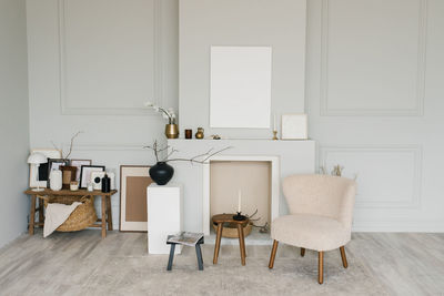 Beautiful interior of a bright minimalist living room with a fireplace and scandinavian-style