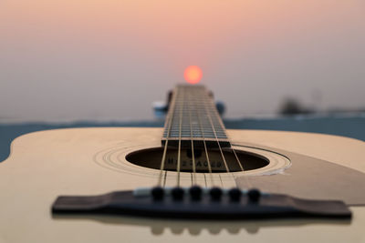 Reflection of color on guitar strings during sunset