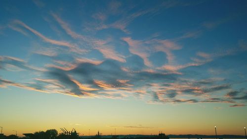 Low angle view of silhouette trees against sky at sunset