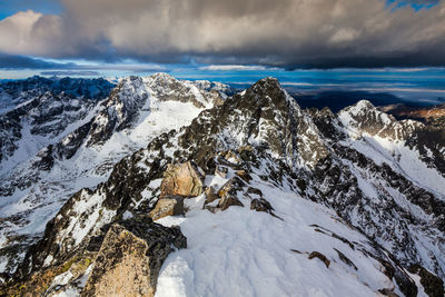 Scenic view of snow covered mountains against sky