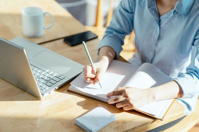 Midsection of man working at office