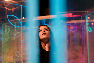 Portrait of a smiling young woman standing at night