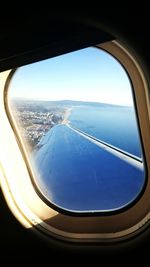 Blue sea seen through airplane window