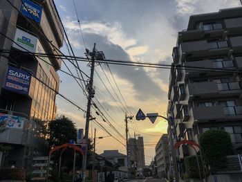 Low angle view of buildings against sky during sunset