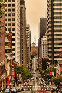 View of city street and buildings against sky