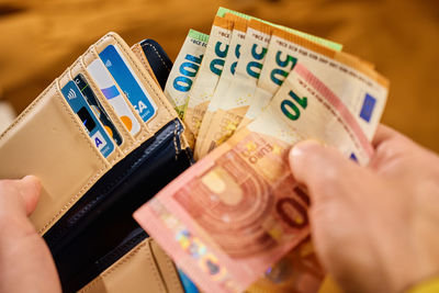 Cropped hand holding paper currency