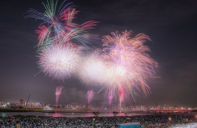 Firework display in city at night